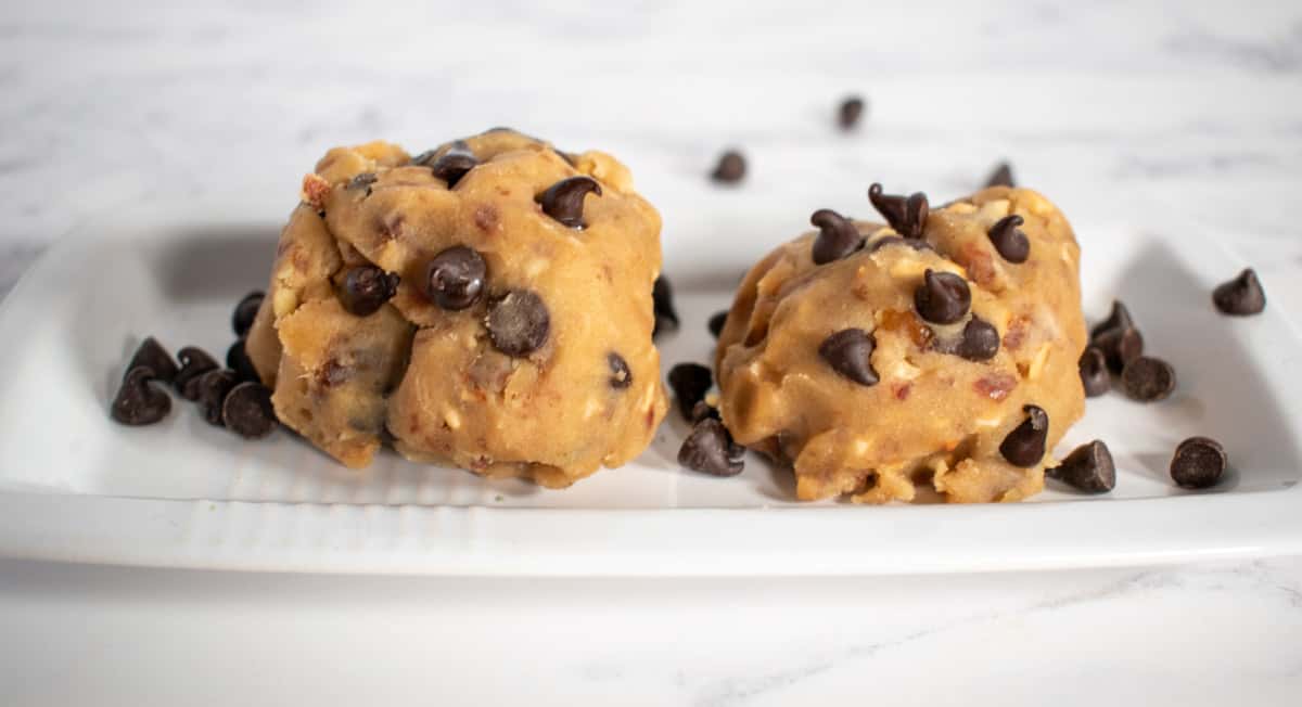 Two scoops of vegan cookie dough on a white platter.