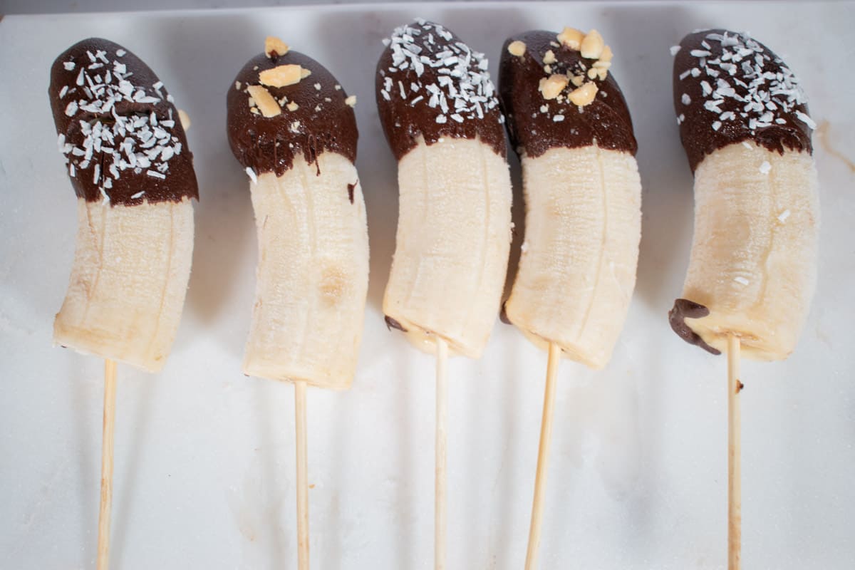 Vegan chocolate banana pops on skewers.