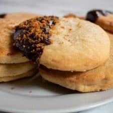 Vegan chocolate shortbread cookies on a white plate.