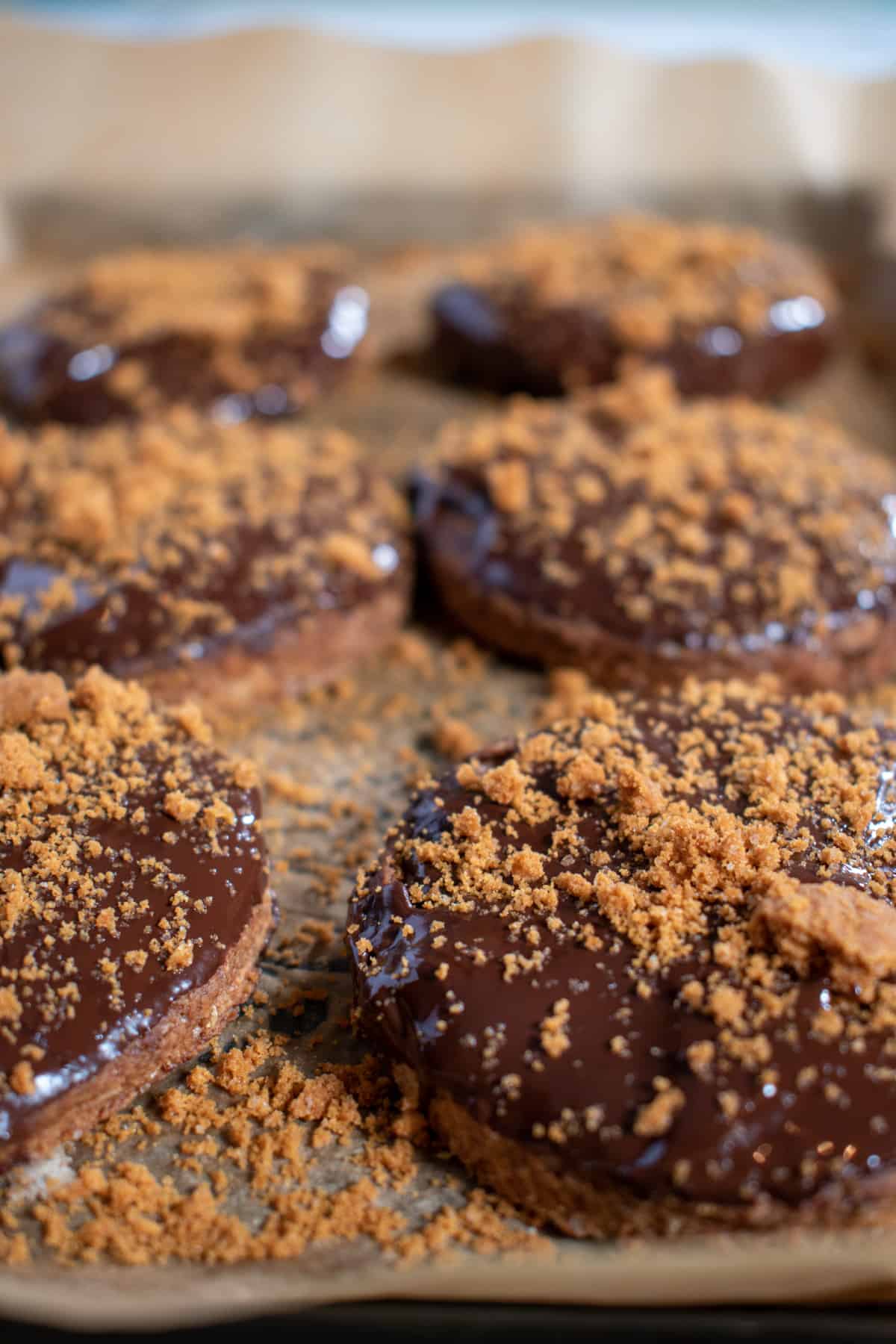 Chocolate digestives on a baking tray.