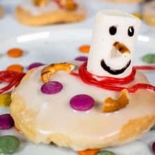 A glazed shortbread cookie on a white plate. Decorated with candy.