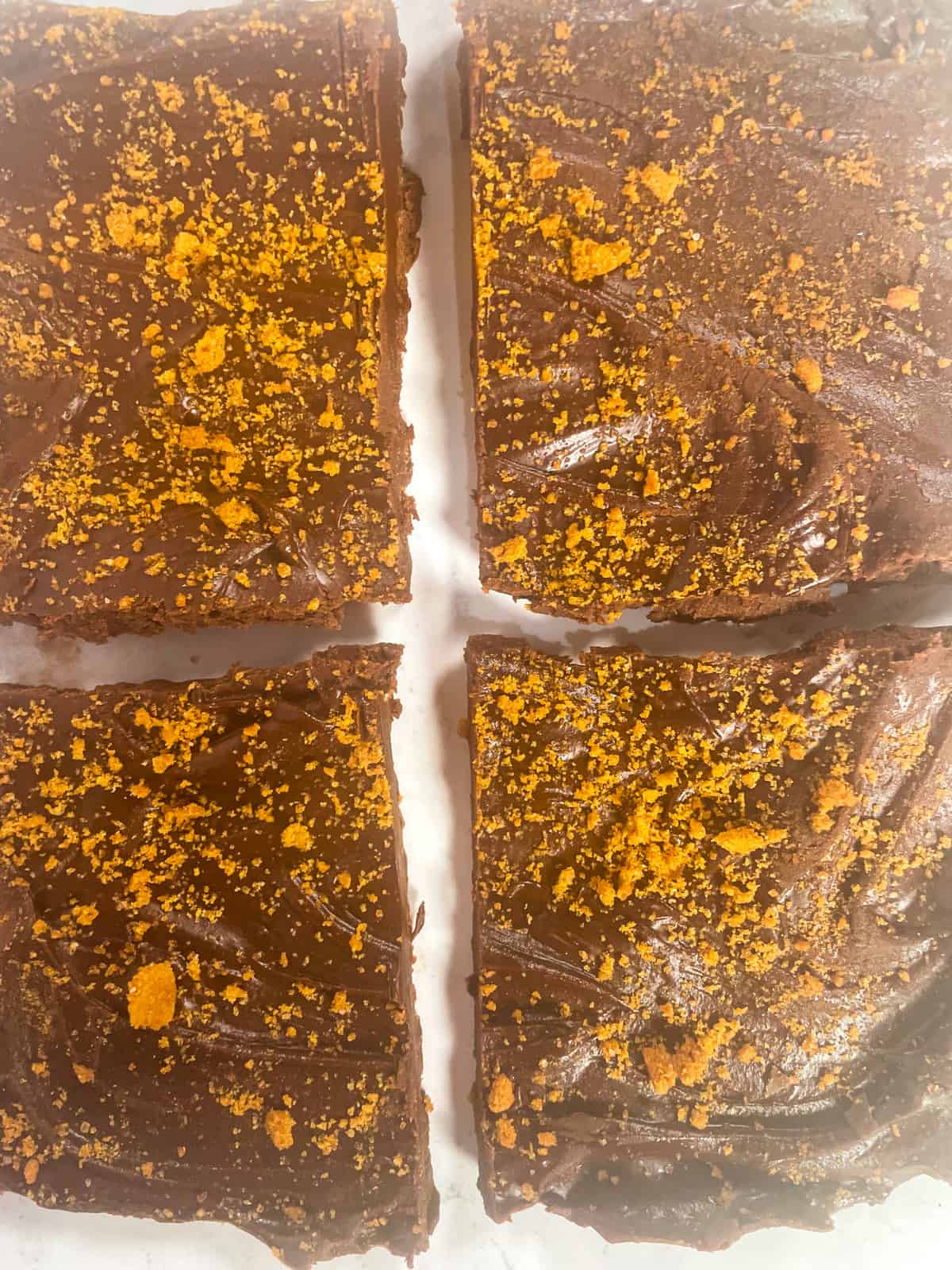 Another up-close shot of vegan chocolate peanut butter fudge. Four square slices.
