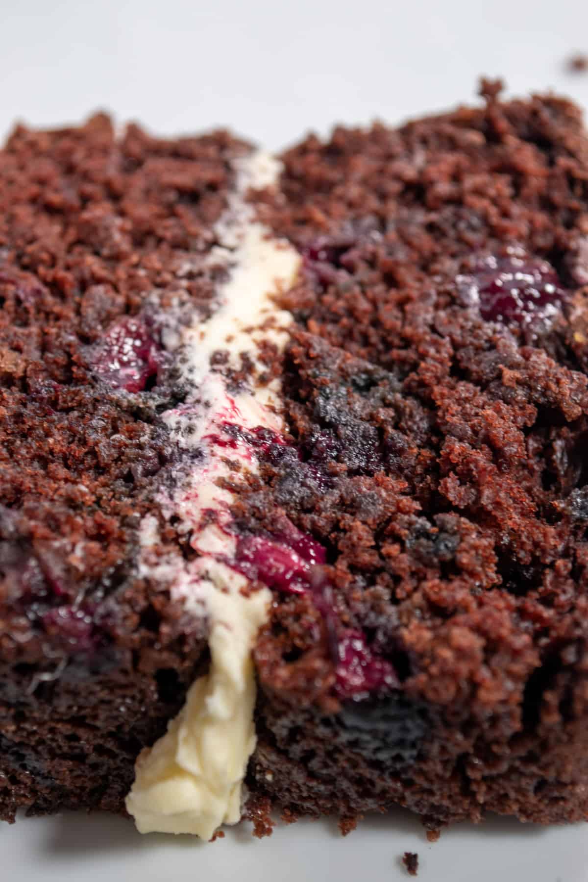 A zoomed in shot of my chocolate eggless blueberry cake. It's moist and the blueberries have burst.