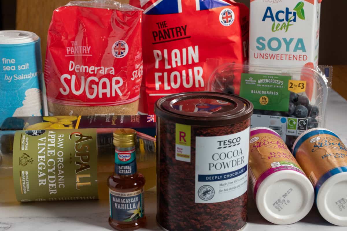 A shot of the ingredients needed to make an eggless chocolate blueberry cake.