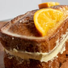 A sicilian lemon loaf cake with sliced orange halves on top to garnish.