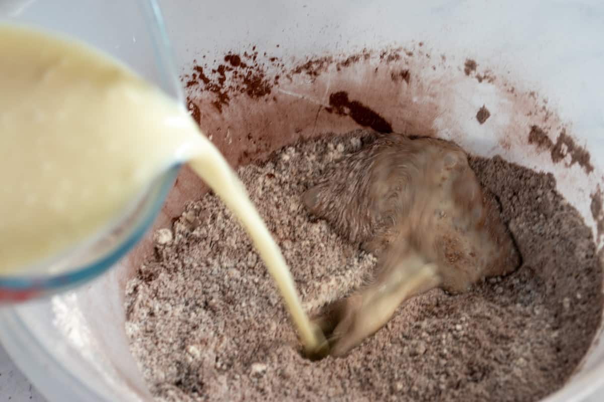 A photo of the curdled soy milk being added to the dry ingredients.