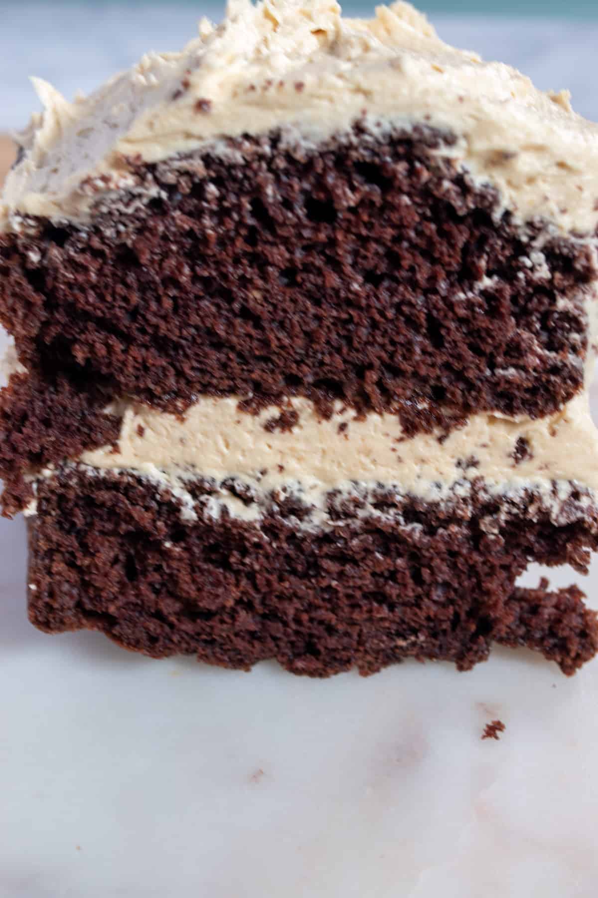 A close up photo of a whole loaf of my eggless peanut butter cake. The front has been sliced off. 