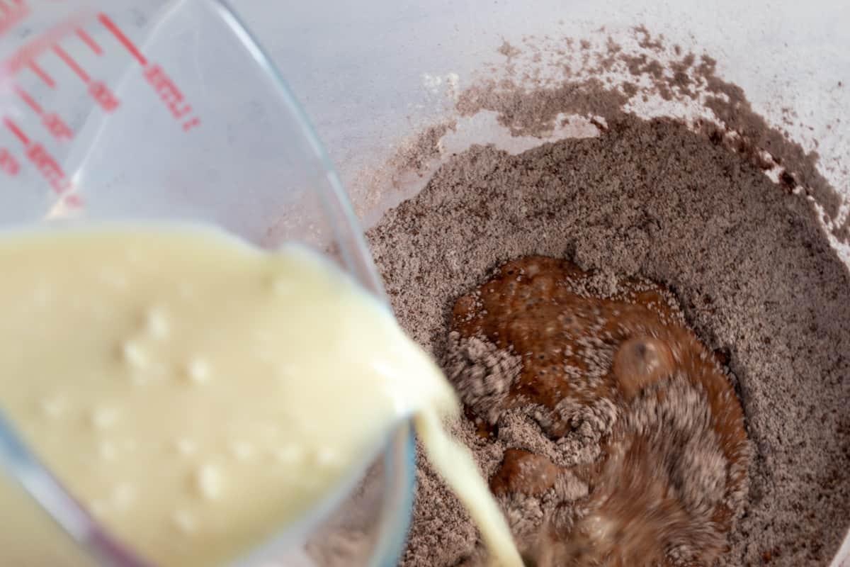 A shot of the curdled soy milk being added to the dry ingredients.