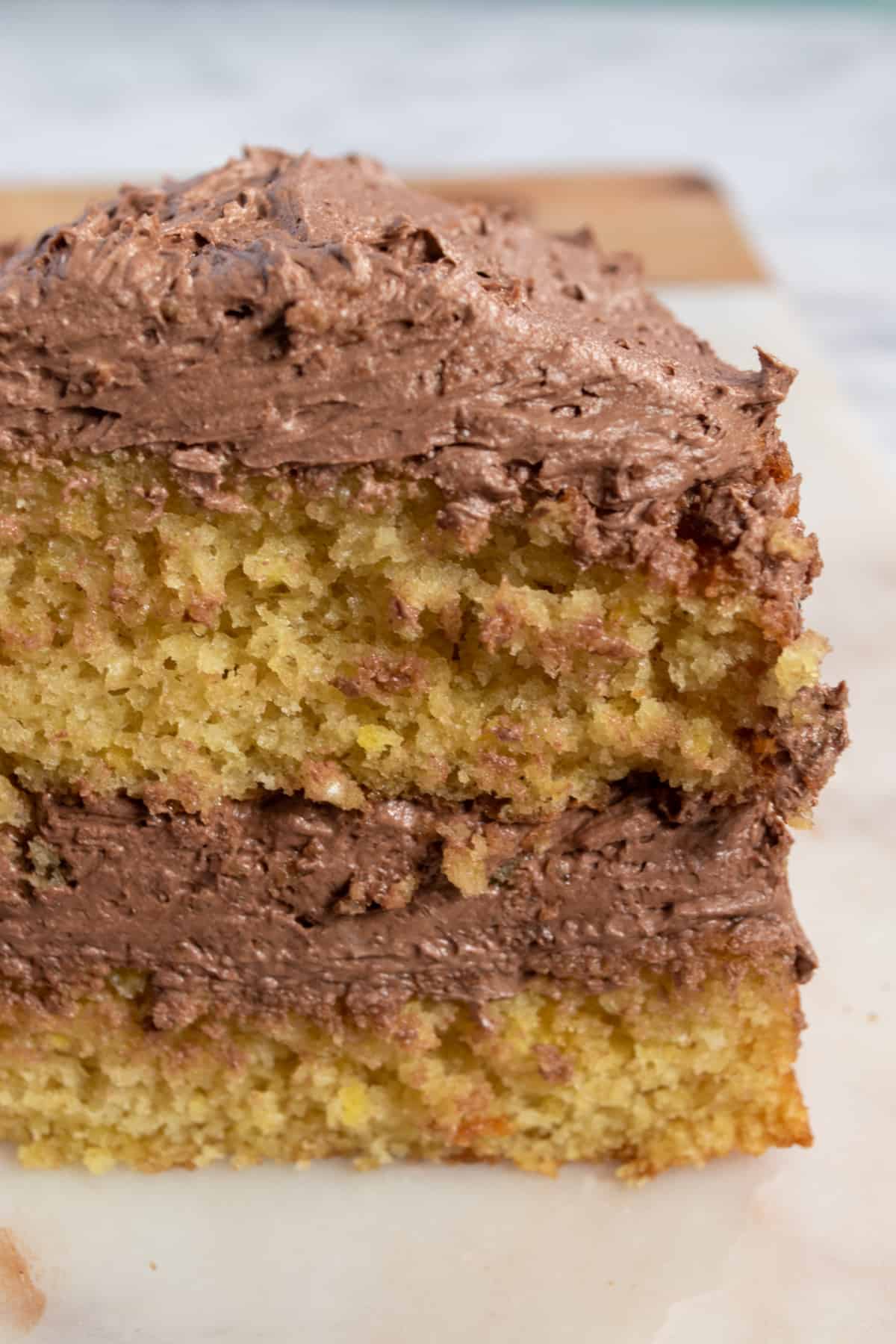 A photo of a full loaf of my chocolate lemon cake with lots of chocolate buttercream in the centre.