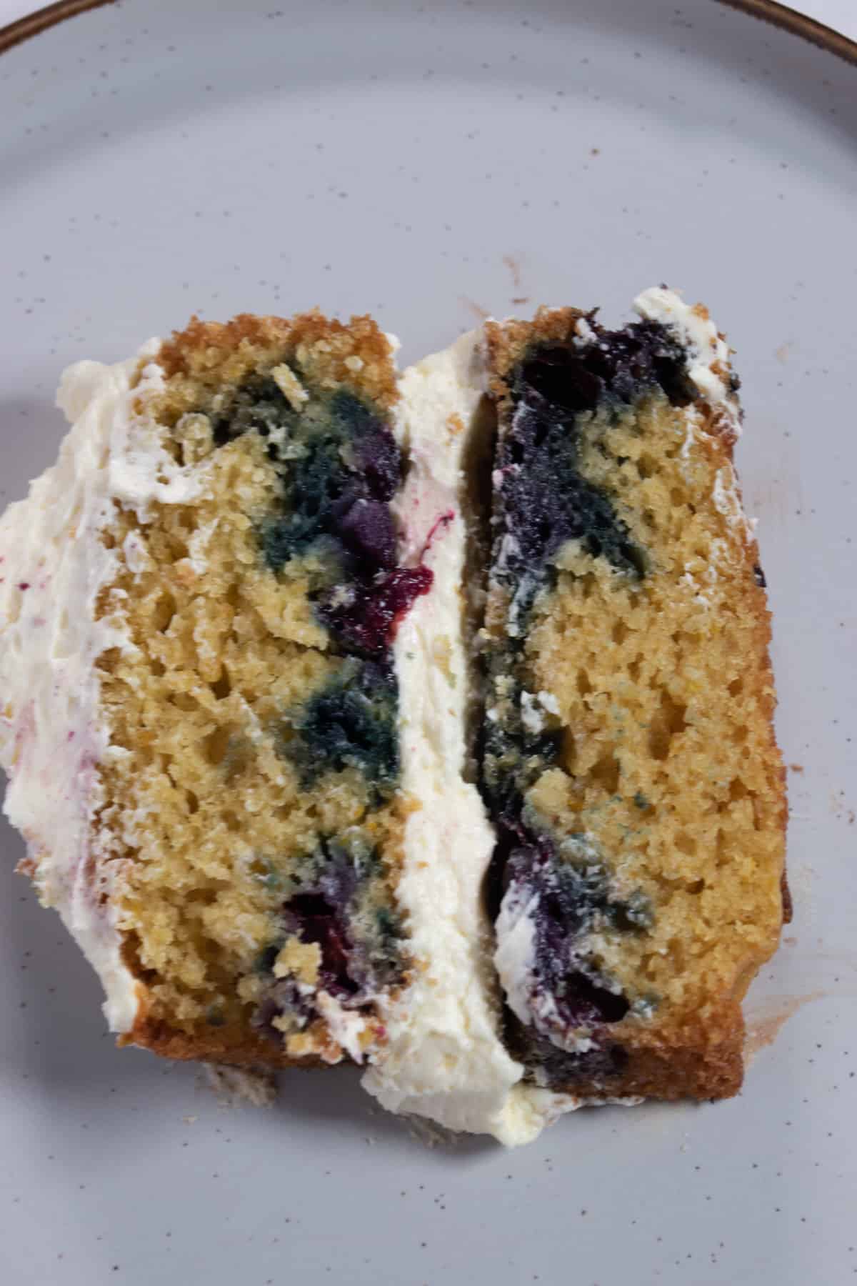 A large chunky slice of my orange blueberry cake on a white plate.