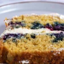 A thick slice of my eggless orange blueberry cake with vanilla buttercream.