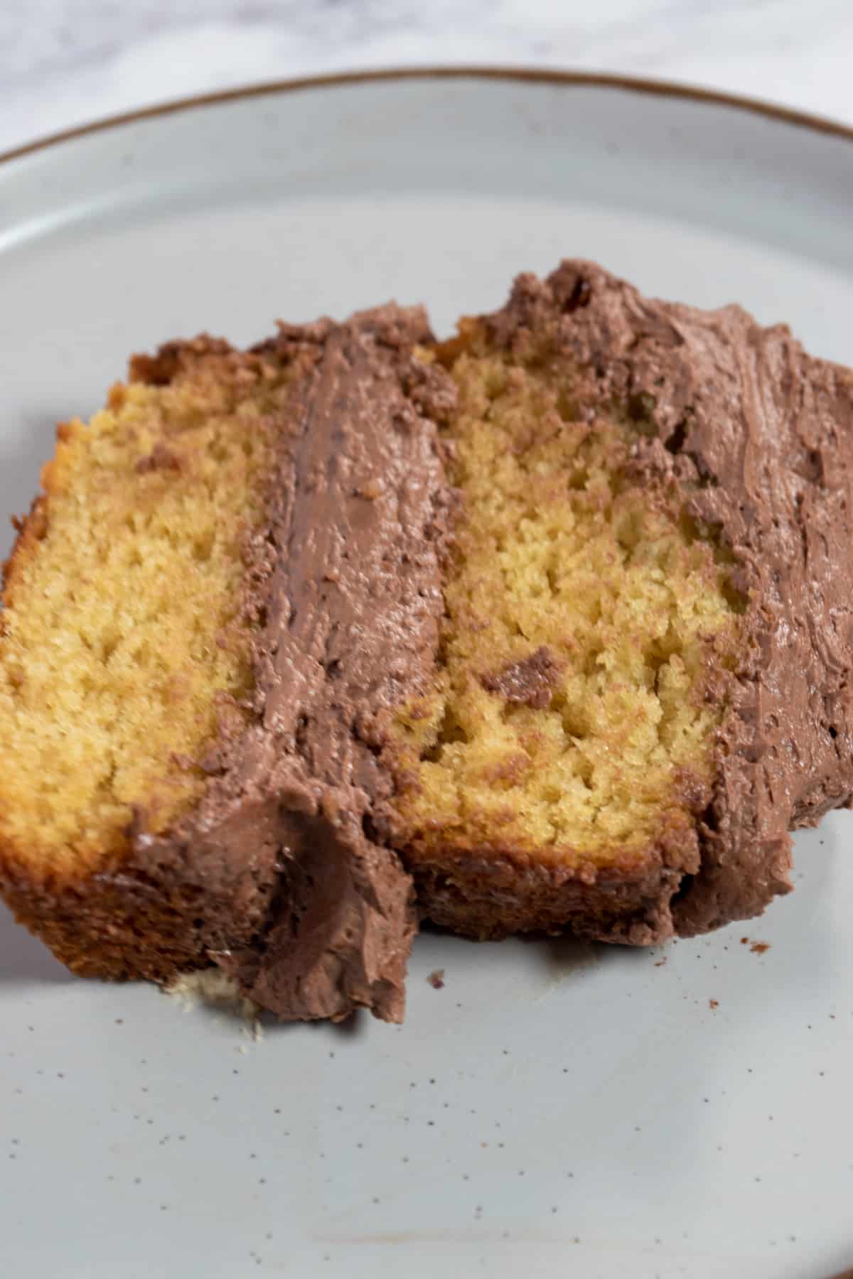 A photo of a thin slice of my chocolate vanilla cake.