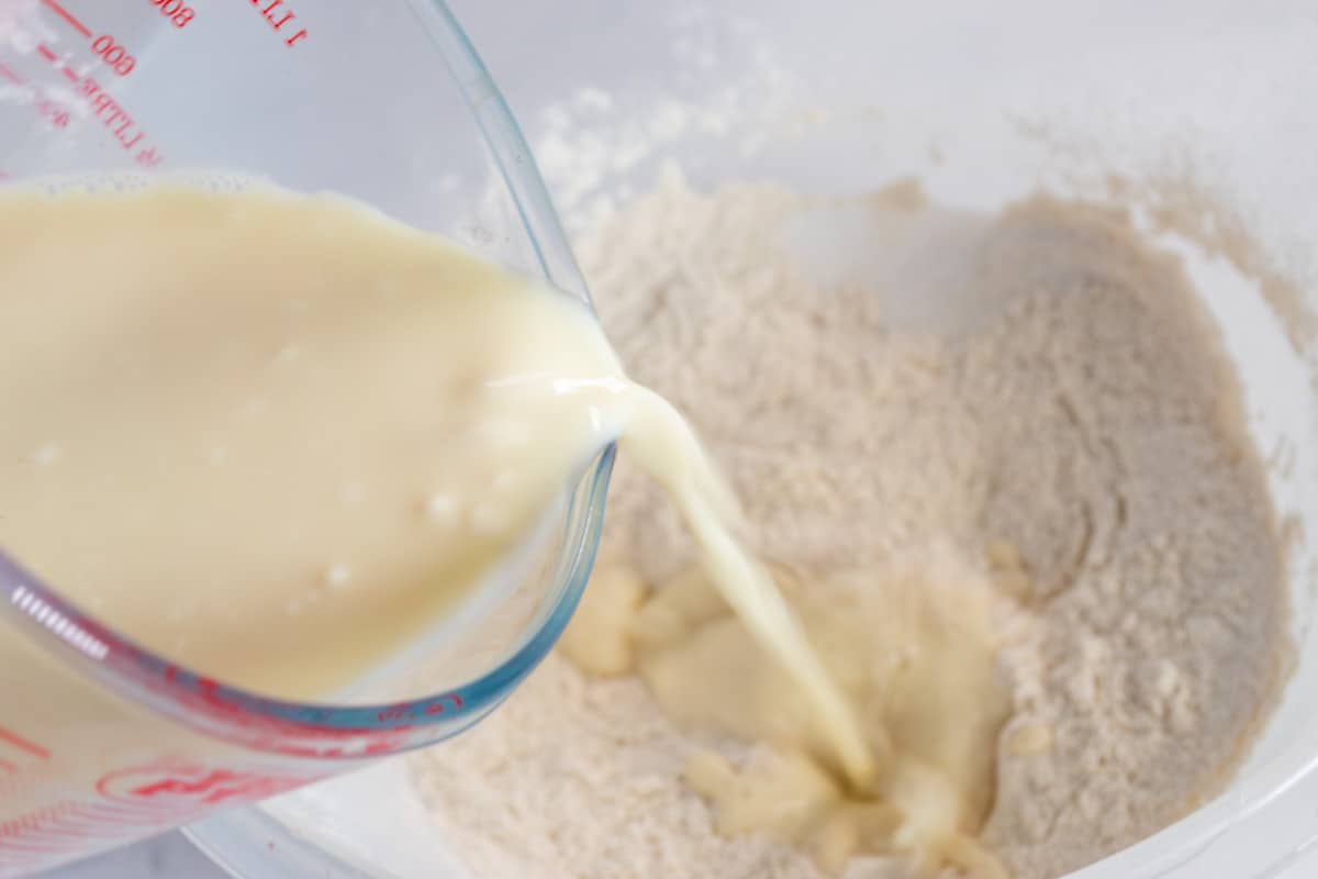 A shot of the curdled soy milk being added to the dry ingredients.