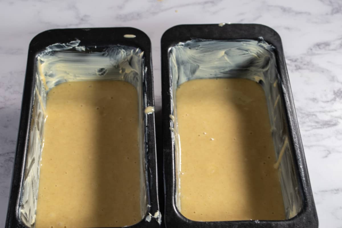 A photo of the eggless chocolate vanilla cake batter in the cake pans.