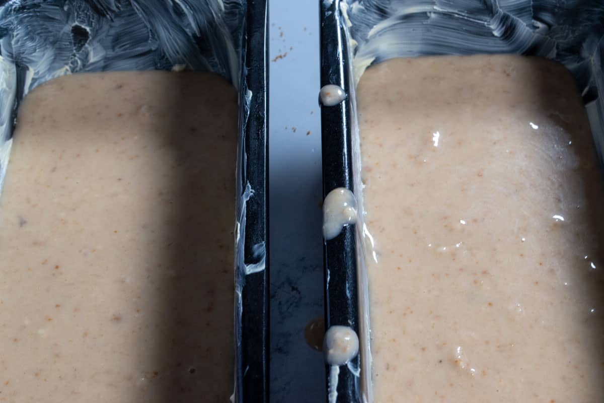 The vegan biscoff banana cake batter  inside the cake pans. 