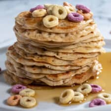 A large stack of my vegan brown sugar with colourful vegan cereal and maple syrup on top.