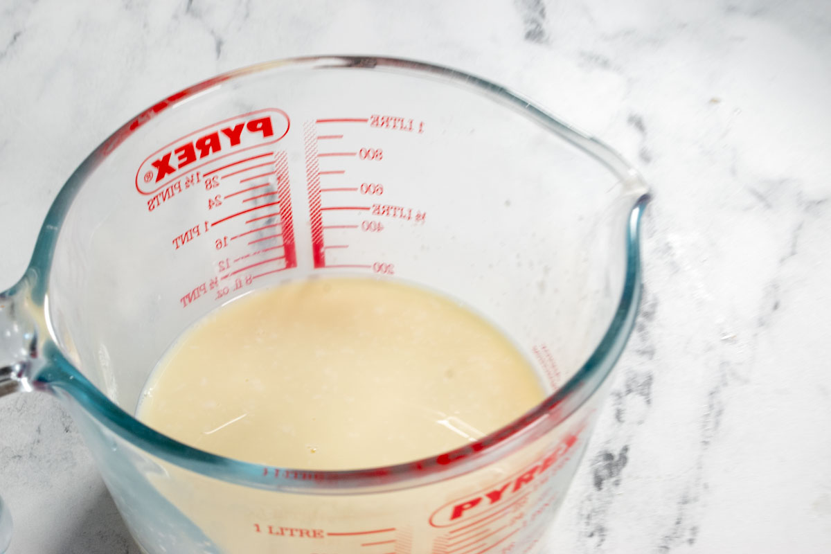 The vegan buttermilk curdling in a pyrex jug. 