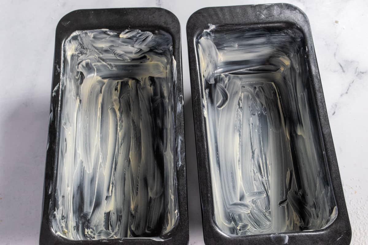 Two greased cake loaf pans. 