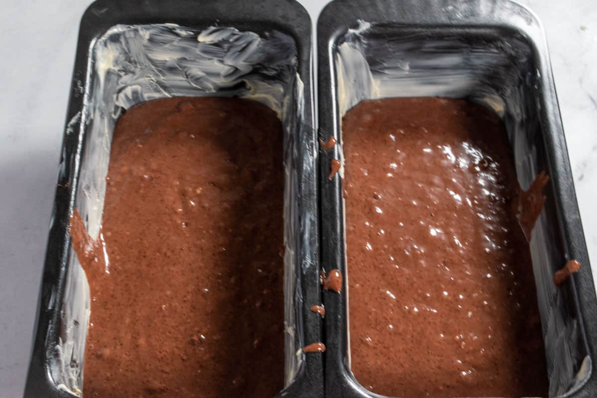 The cake batter inside the two tins. 