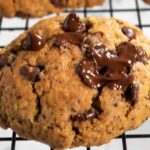 A close up shot of an espresso cookie. Lots of melted chocolate chips on top.