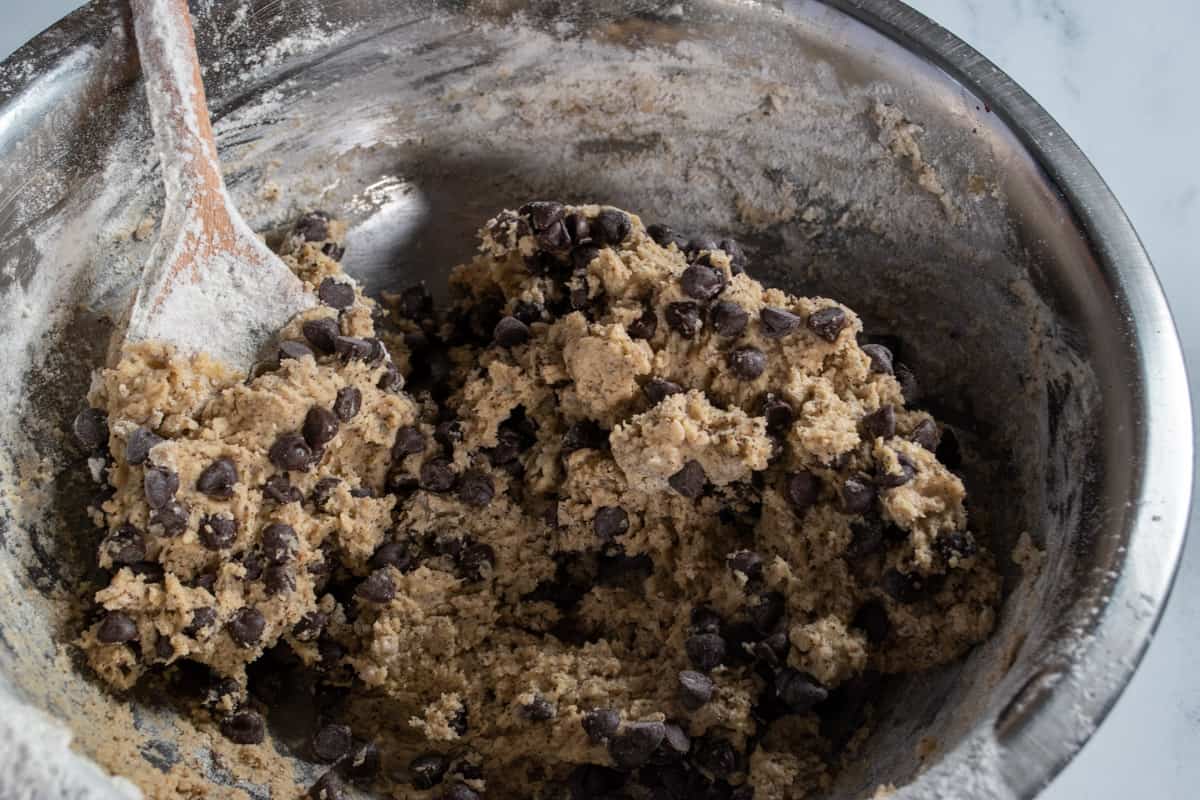 The vegan espresso chocolate chip cookies cookie dough is fully formed. The chocolate chip have been folded in. 