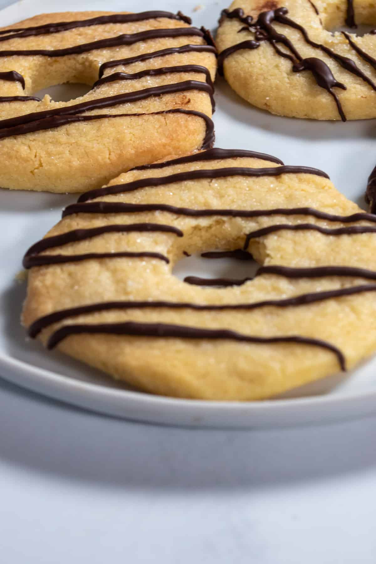 Three of my fudge stripe cookies sitting neatly on a white platter.