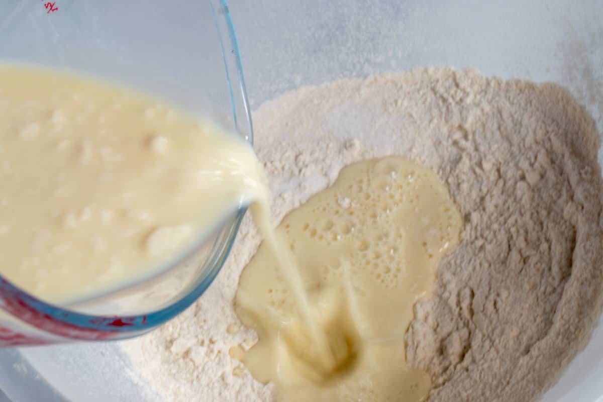 The curdled soy milk being poured into the dry ingredients.