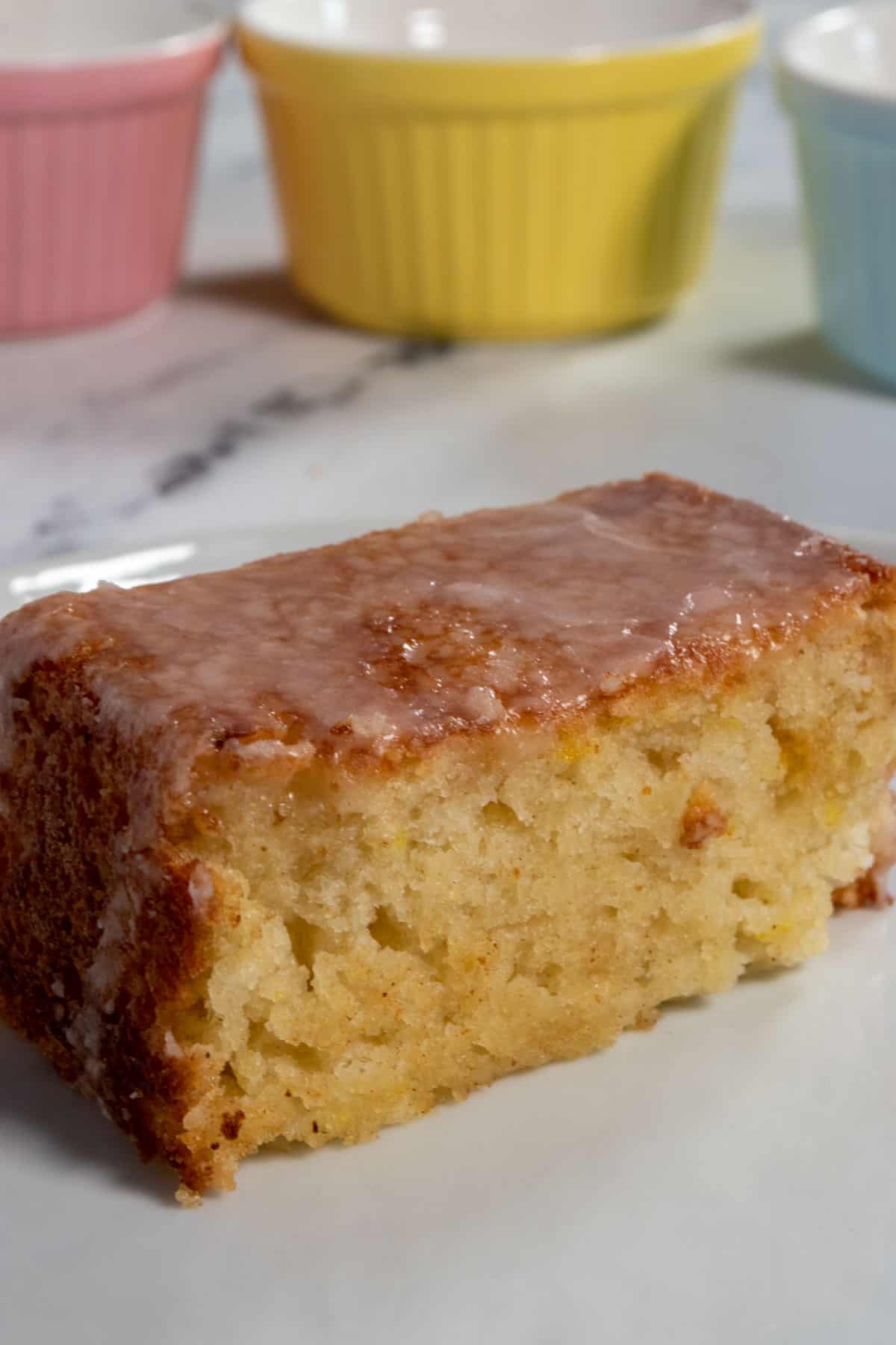 A side angle shot of a fluffy slice of my vegan lemon drizzle cake. 