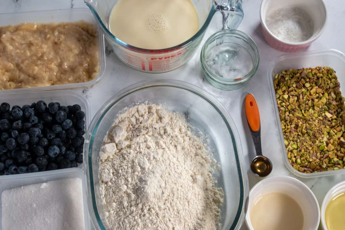 A shot of the ingredients needed to make pistachio muffins with blueberries. 