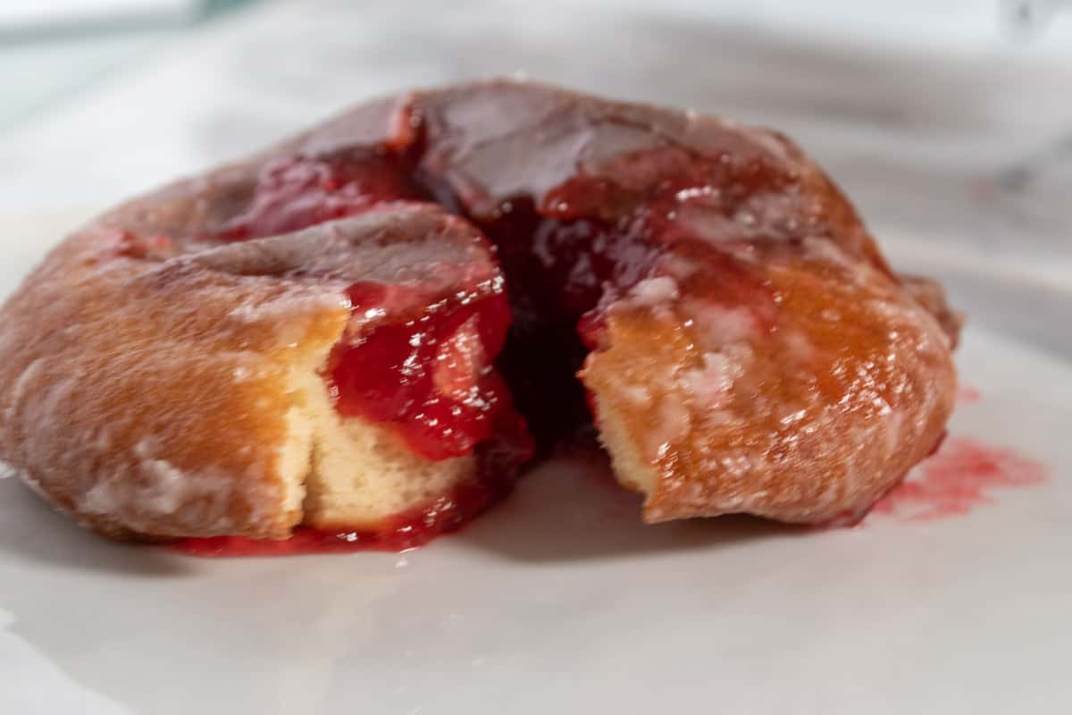The raspberry jelly has been piped into the donuts. 