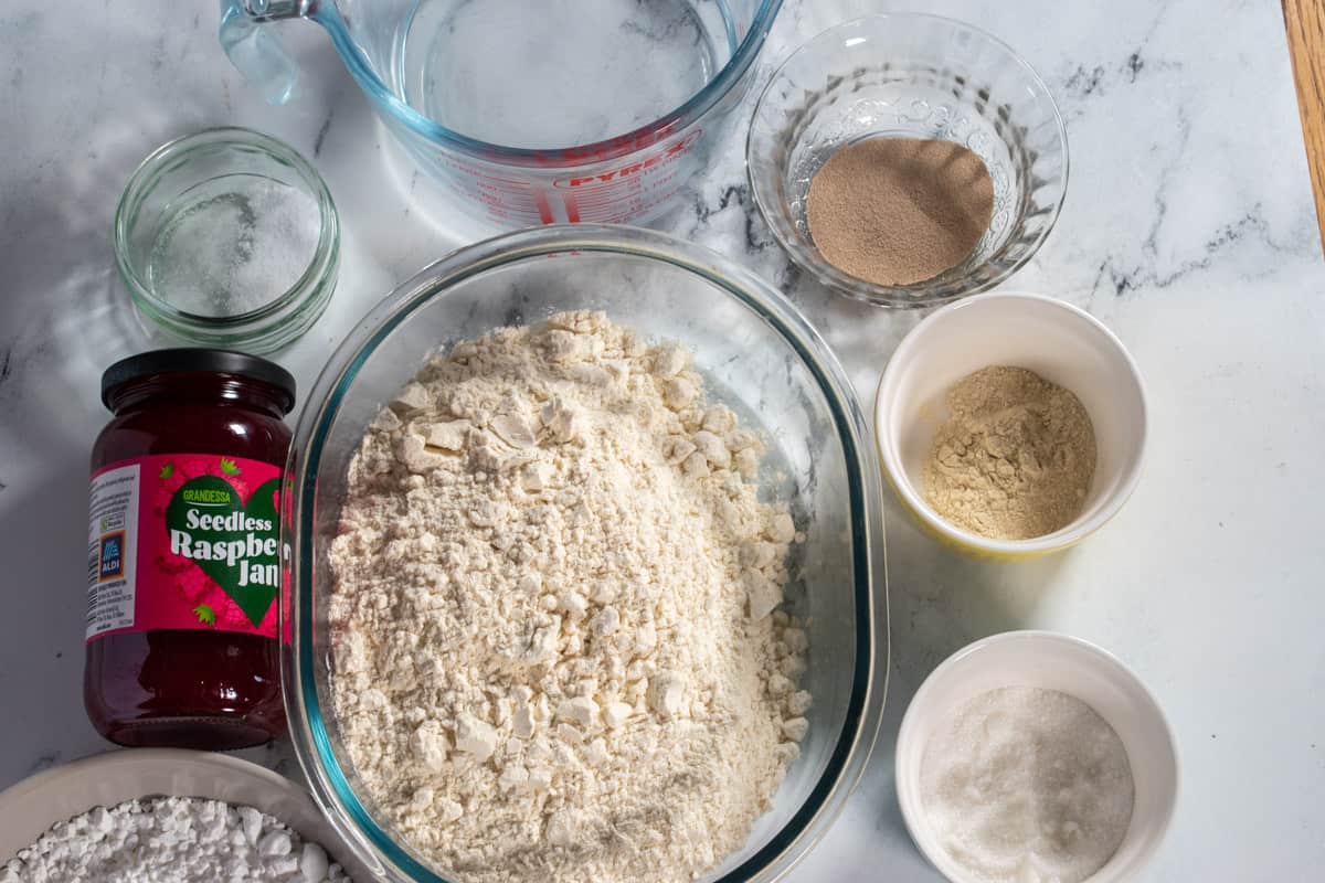 A shot of the ingredients needed to make vegan raspberry filled donuts. 