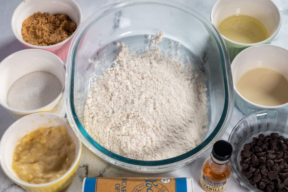 An overhead shot of the ingredients needed to make vegan banana chocolate chip cookies.