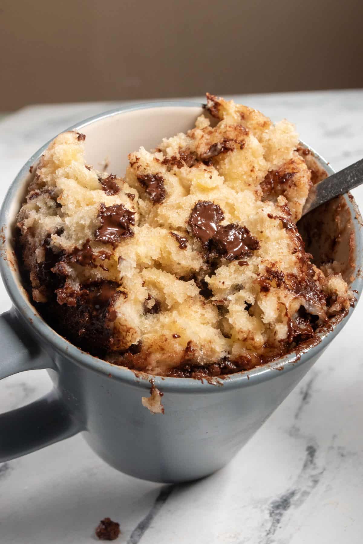 A shot inside the mug showing fluffy cake inside. 