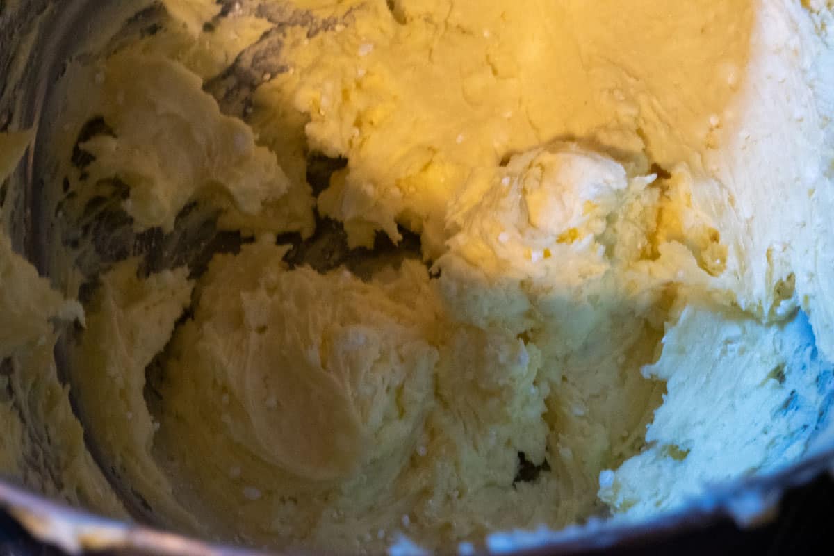 The vegan buttercream ingredients almost combined inside a stand mixer. 