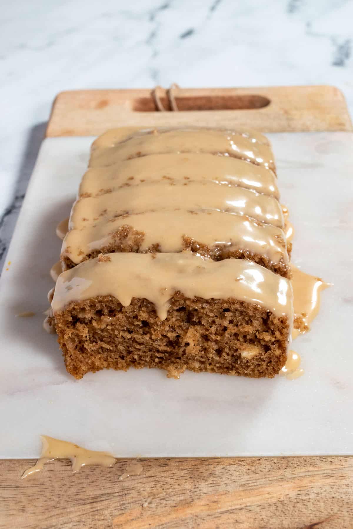 An entire loaf of gingerbread cake sitting on a marble platter.