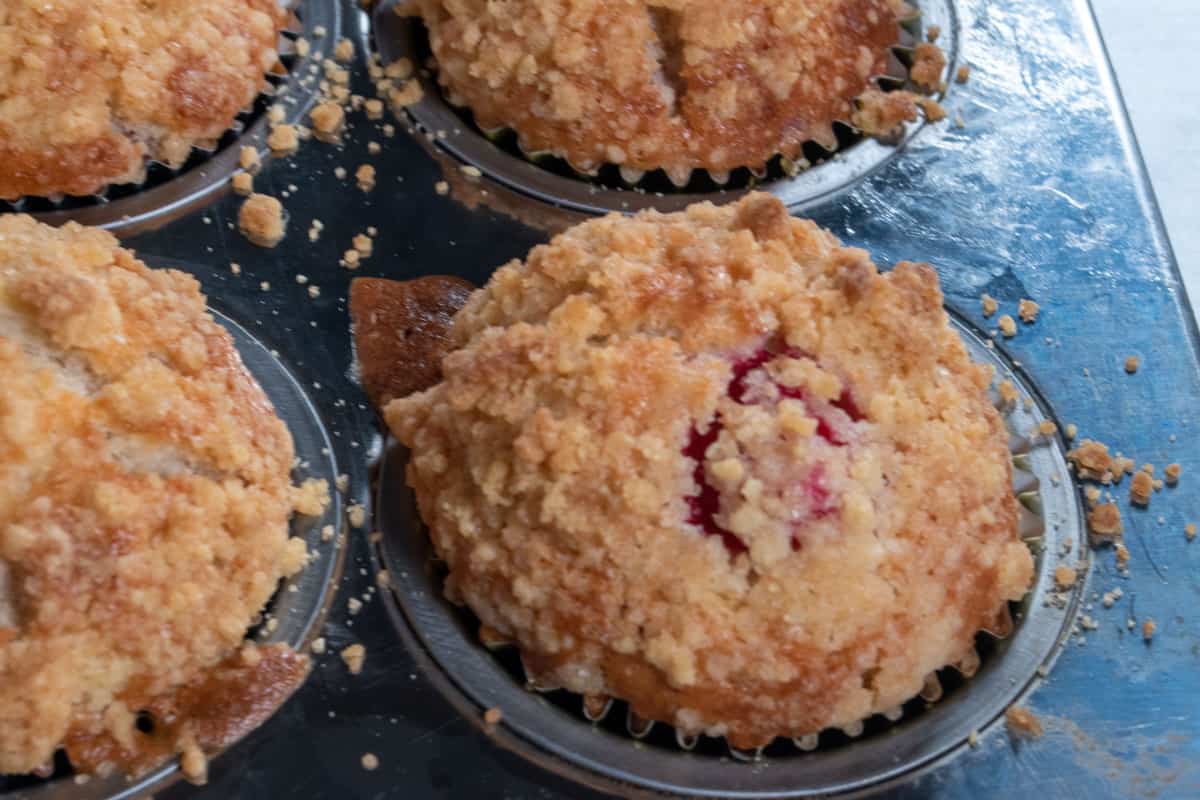 Baked vegan raspberry muffins after just coming out from the hot oven. They are golden brown. 