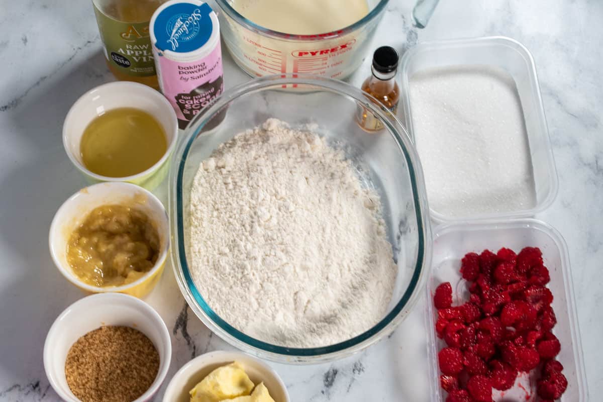 An overhead shot of the ingredients needed to make vegan raspberry muffins.