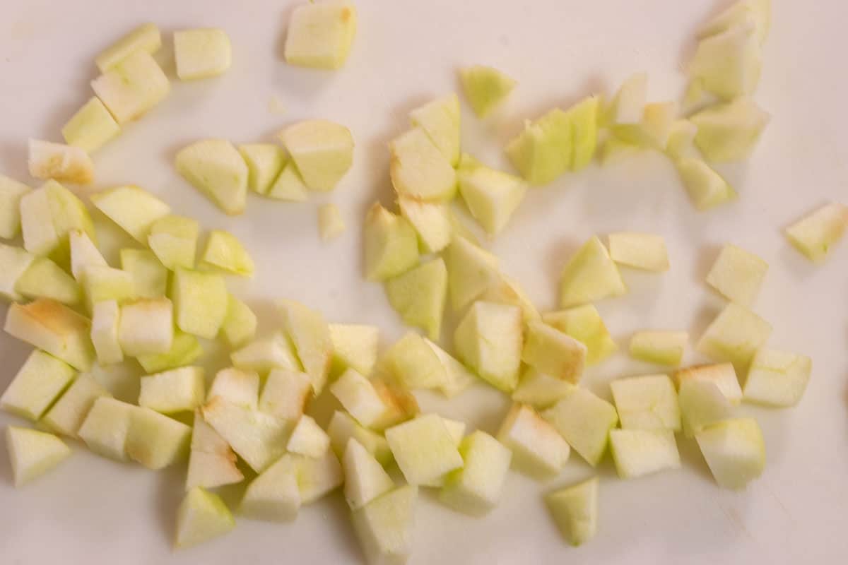 An aerial shot of the apple chopped into small cubes. The outer skin has also been removed. 