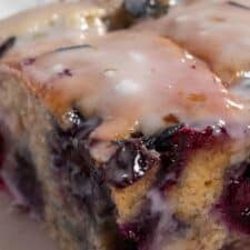A zoomed in shot of my vegan blueberry banana cake. The blueberry glaze is dripping down the sides of the cake.