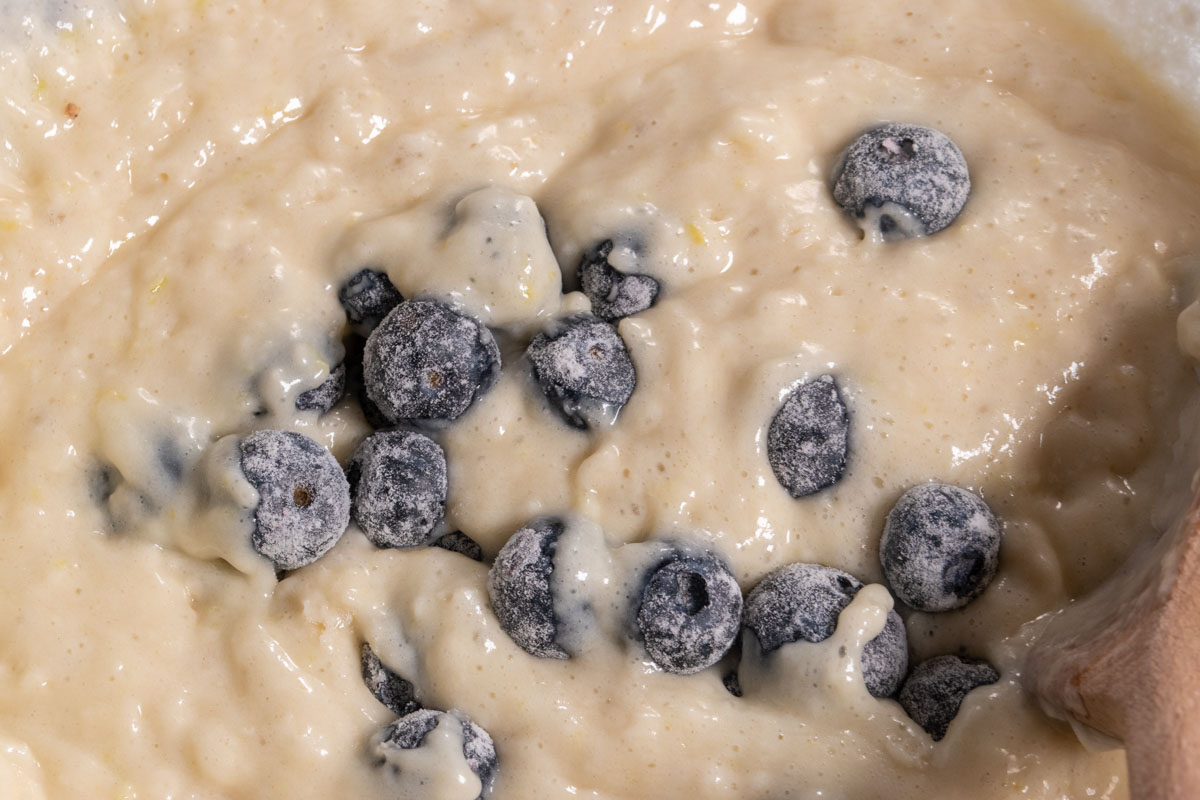 The dry ingredients have been folded into the wet. The blueberries have also been folded into the batter.