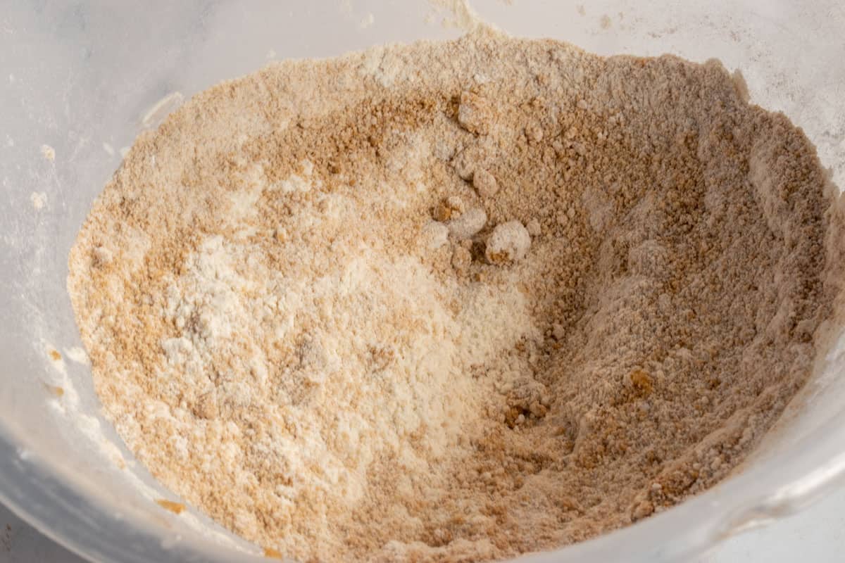 The dry ginger cake ingredients, combined inside a plastic mixing bowl. 