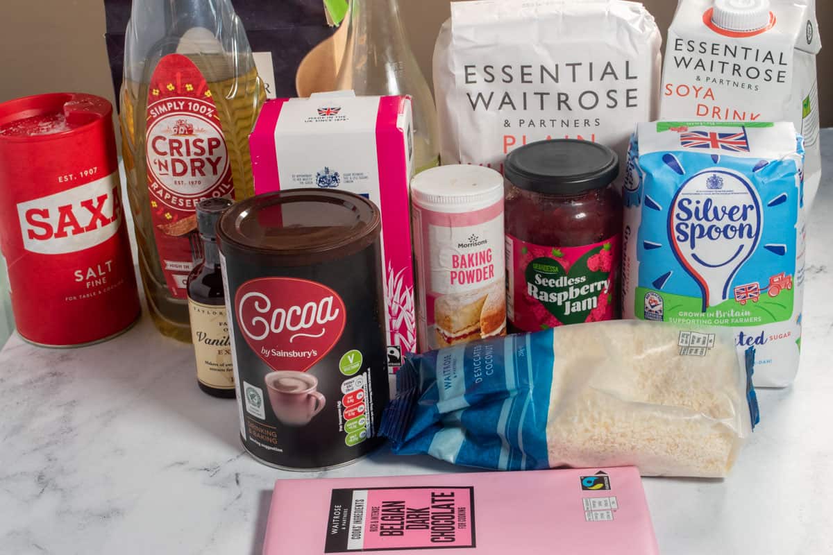 The many ingredients that you will need to make my vegan Lamingtons sitting on a white, marble backdrop.