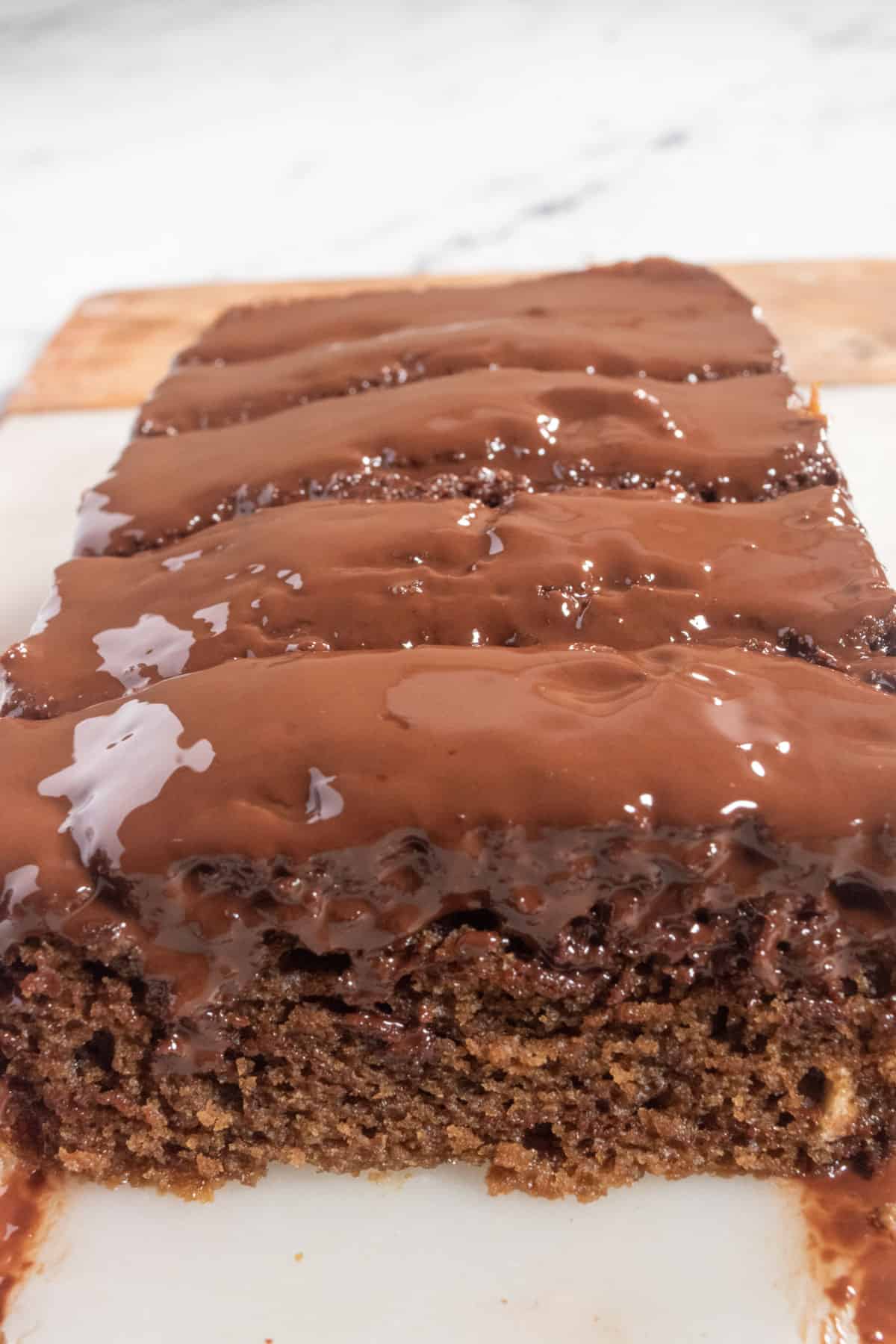 A whole loaf of chocolate mocha cake. The glaze has a shine to it.