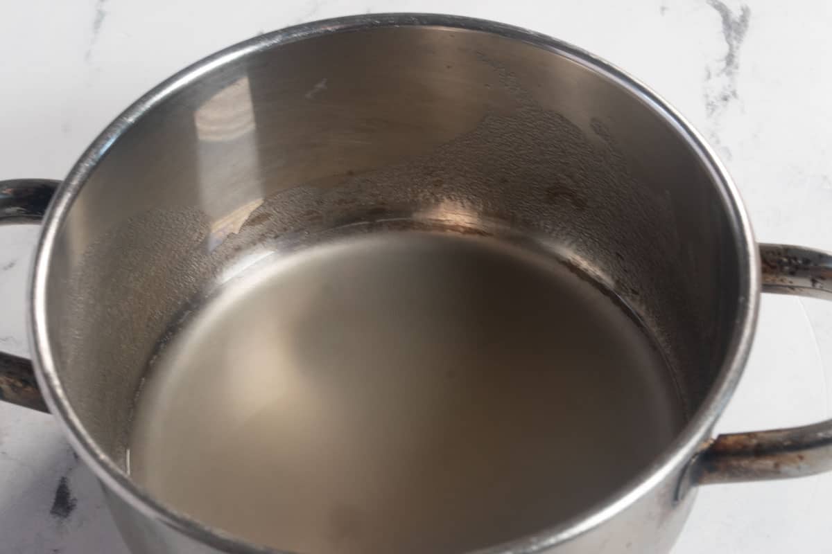 A steel pan containing water with dissolved agar powder.