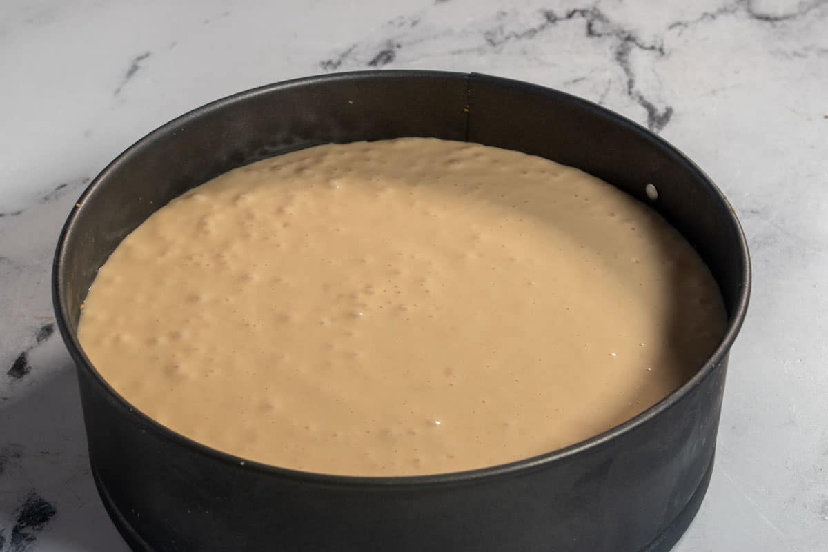 The peanut butter filling has been poured into the cake tin and is ready to be chilled in the fridge. 
