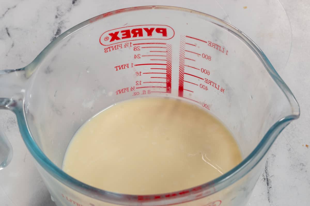 Soy milk curdling into vegan buttermilk in a pyrex glass. 