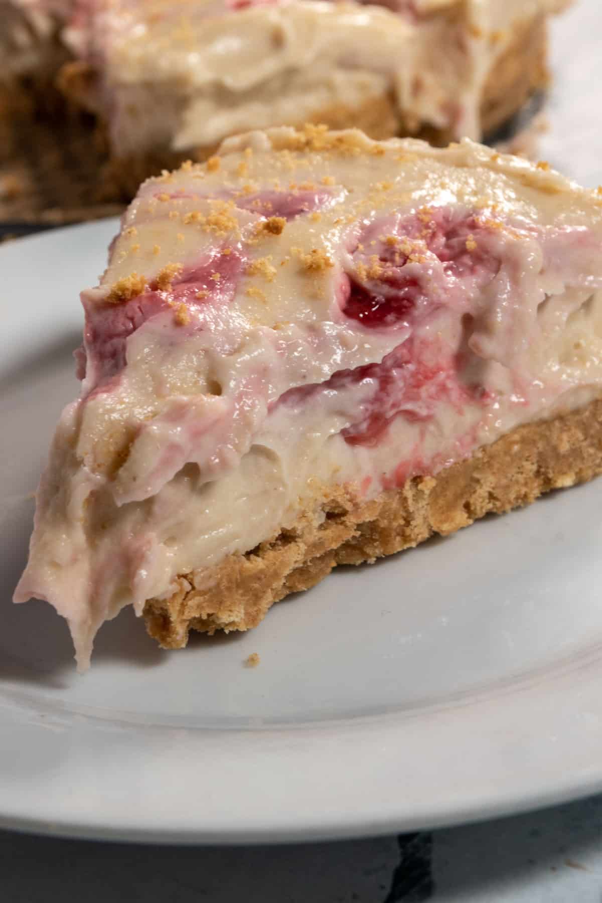 A large slice of my vegan strawberry shortcake cheesecake. This piece has lots of strawberry compote throughout. 