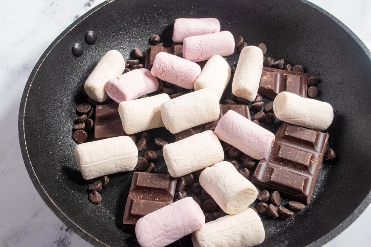 The vegan marshmallows have been added and placed on top of the chocolate. 