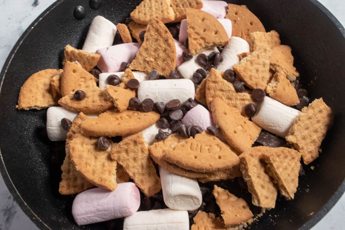 The Digestives have been placed on top of the marshmallows along with a few more chocolate chips. It is ready to go in the oven.