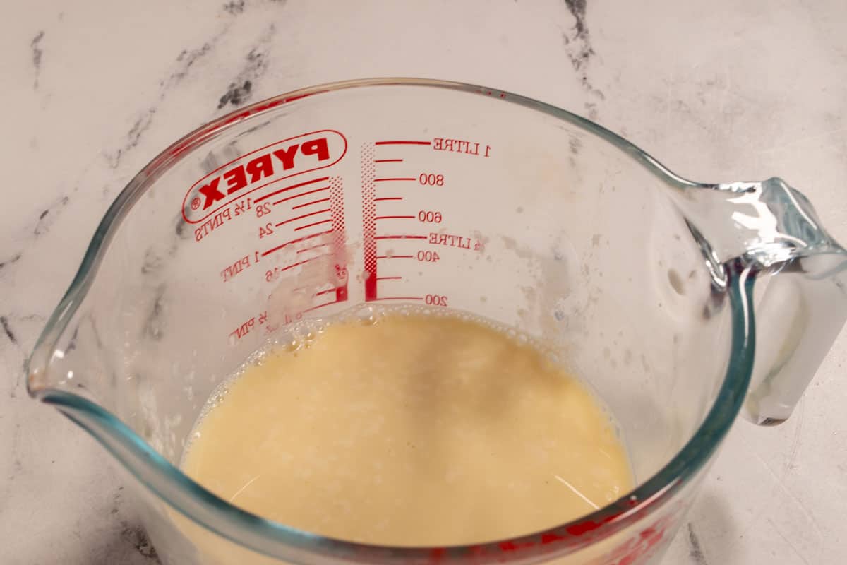 The vegan buttermilk curdling inside a jug.